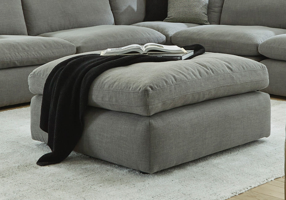 Elyza Smoke Oversized Ottoman in front of couch