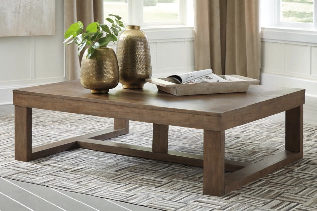 Cariton Coffee Table in a living room with plants and news paper on top